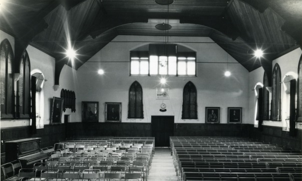 Interior of Norman Morrison Memorial Hall, circa 1967 with the W R Jewell Plaque and the electric clock on the rear wall.